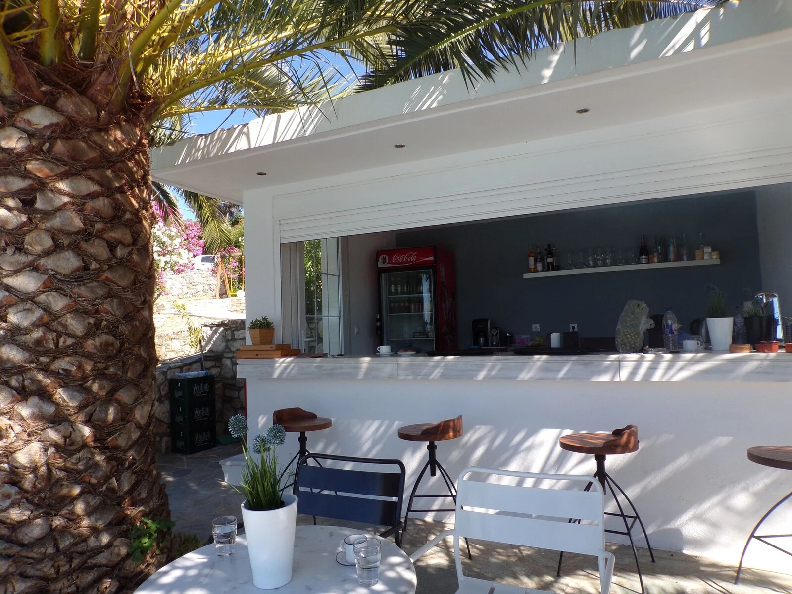 Poolside bar counter with outdoor tables and chairs.